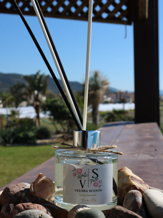 Velora Scents diffuser bottle with sticks on a wooden surface outdoors